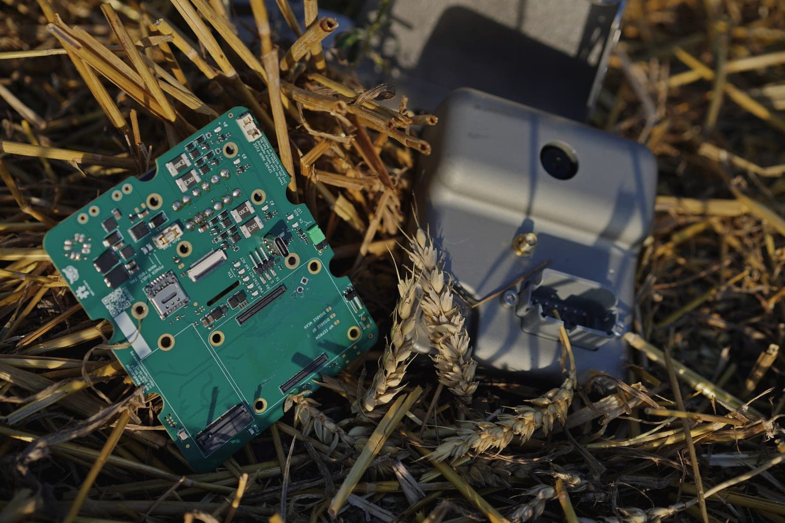 OWL carrier board and enclosure lying in wheat stubble